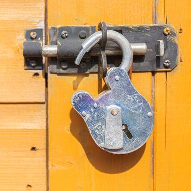 open lock hanging from a door
